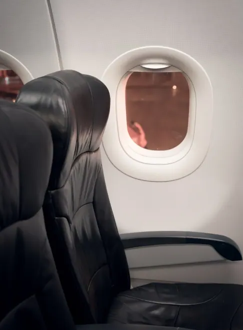 Leather aircraft cabin seat by the window