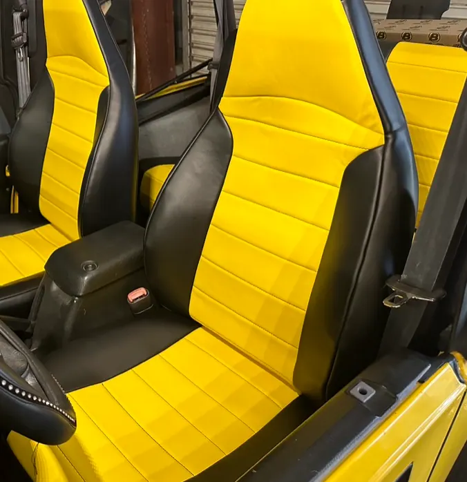 Close-up of the black and yellow custom seat upholstery and stitching