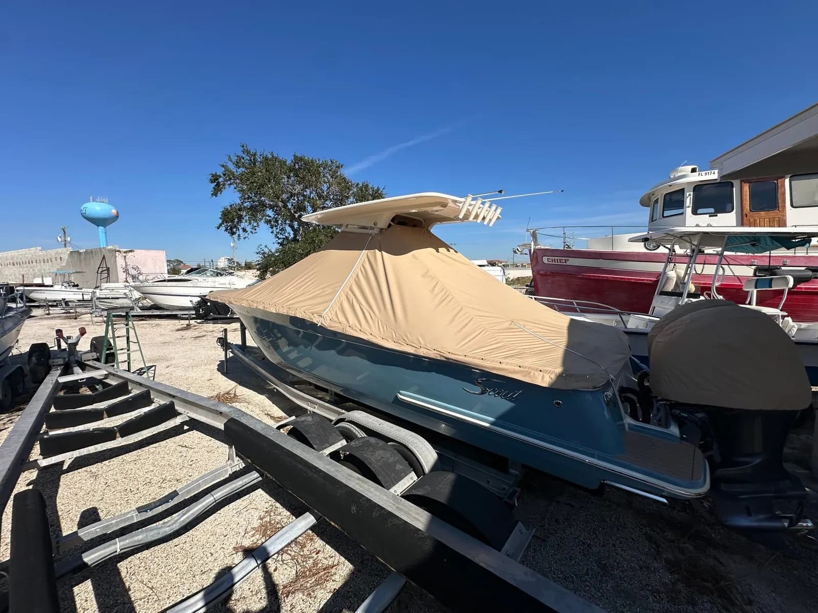 Tan custom boat cover on a trailered center console boat