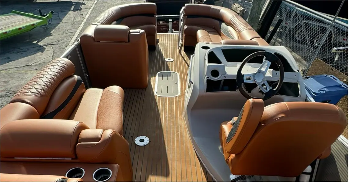 Luxury pontoon helm area with burnt orange marine vinyl upholstery