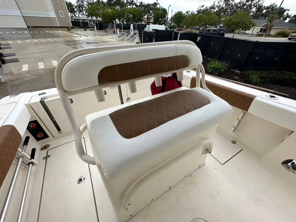 Aft bench seat with white and tan diamond-stitch inserts on a center console