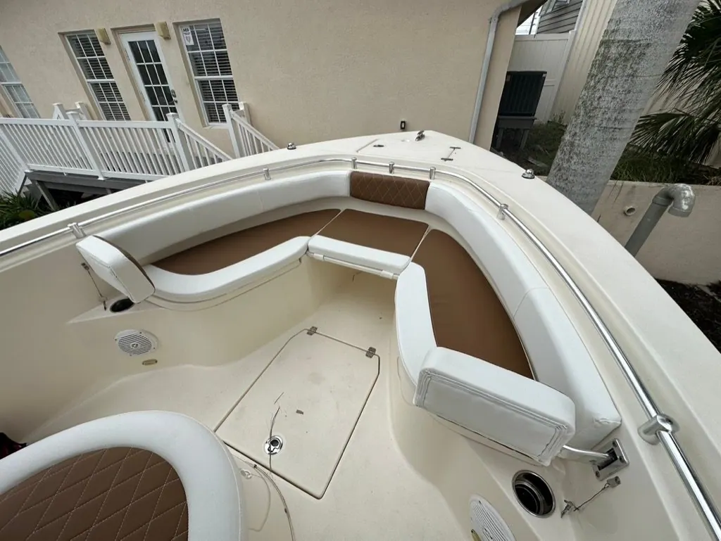 Bow seating with two-tone white and tan diamond-stitched marine vinyl on a center console boat