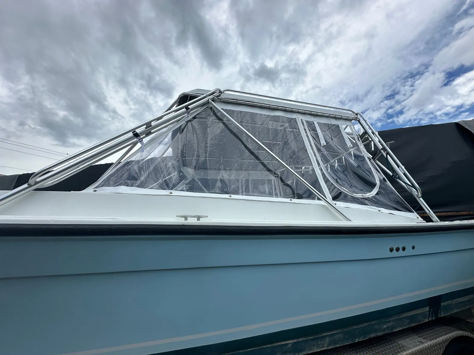 Clear vinyl windshield enclosure on a cabin boat