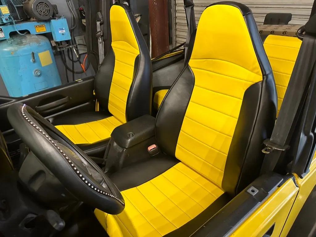 Black and yellow custom vinyl front seats installed in a Jeep at Apogee Upholstery, Venice, FL