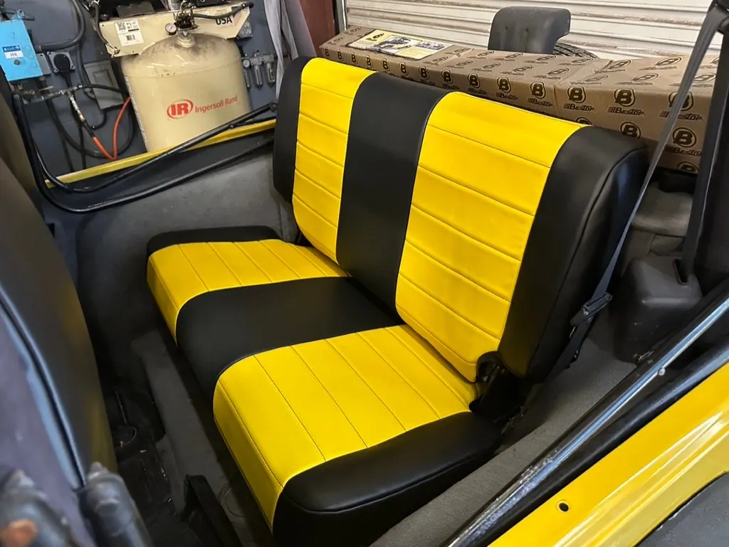 Custom black and yellow vinyl rear bench seat in the Jeep