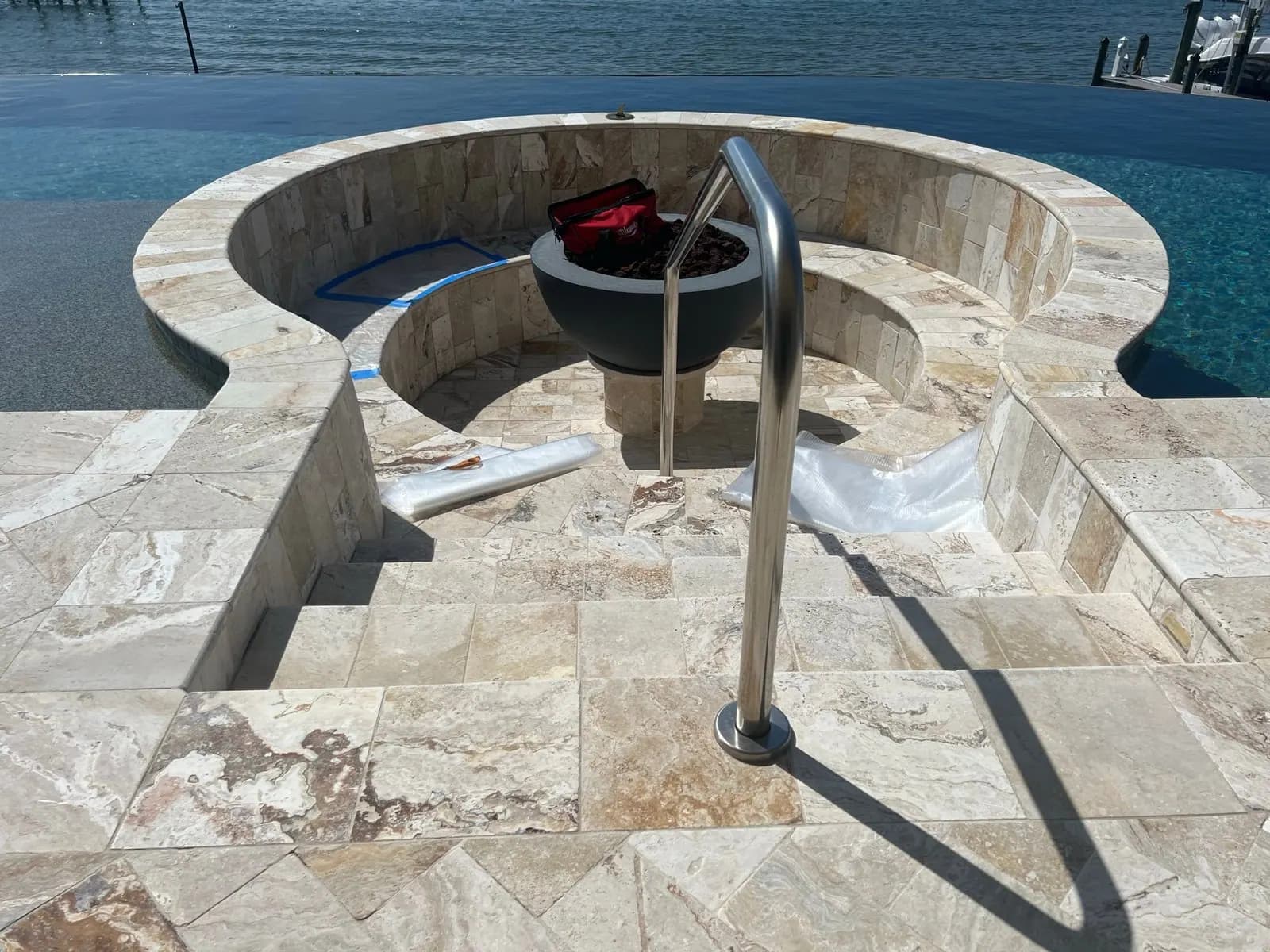 Pattern tape laid out on the curved stone bench for the fire pit cushions
