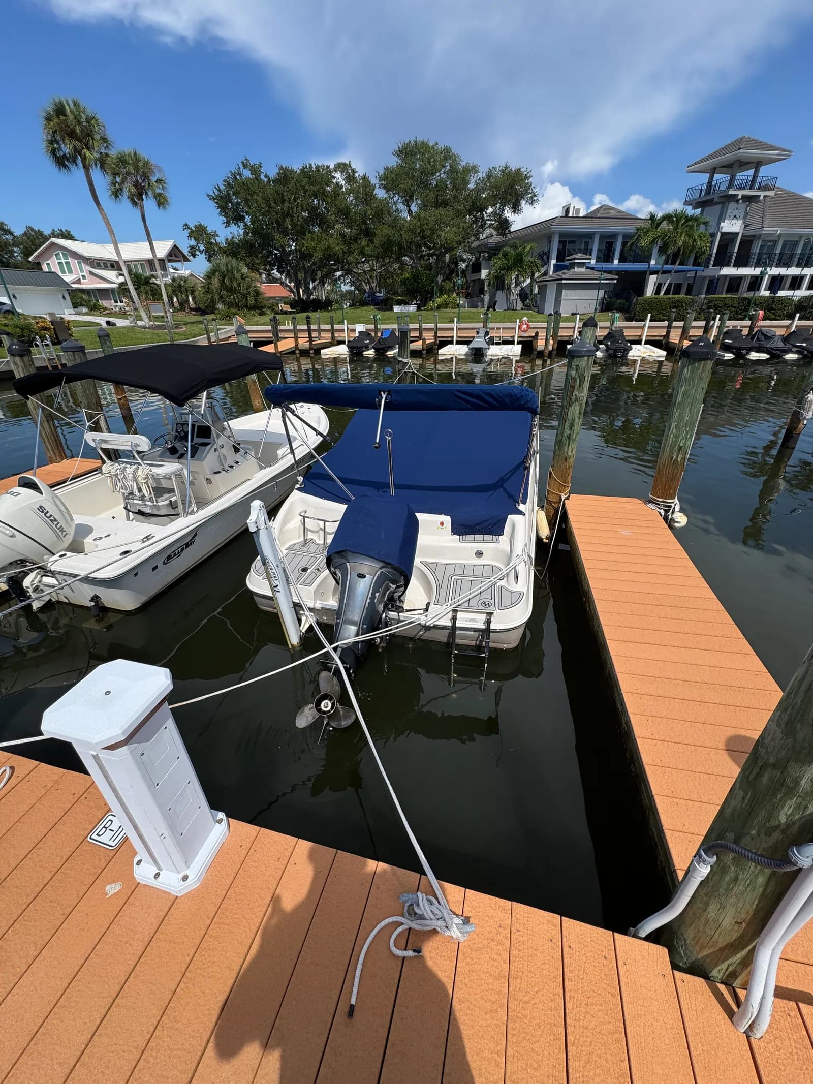 Navy custom mooring cover on a bowrider at a residential canal dock in Venice, FL