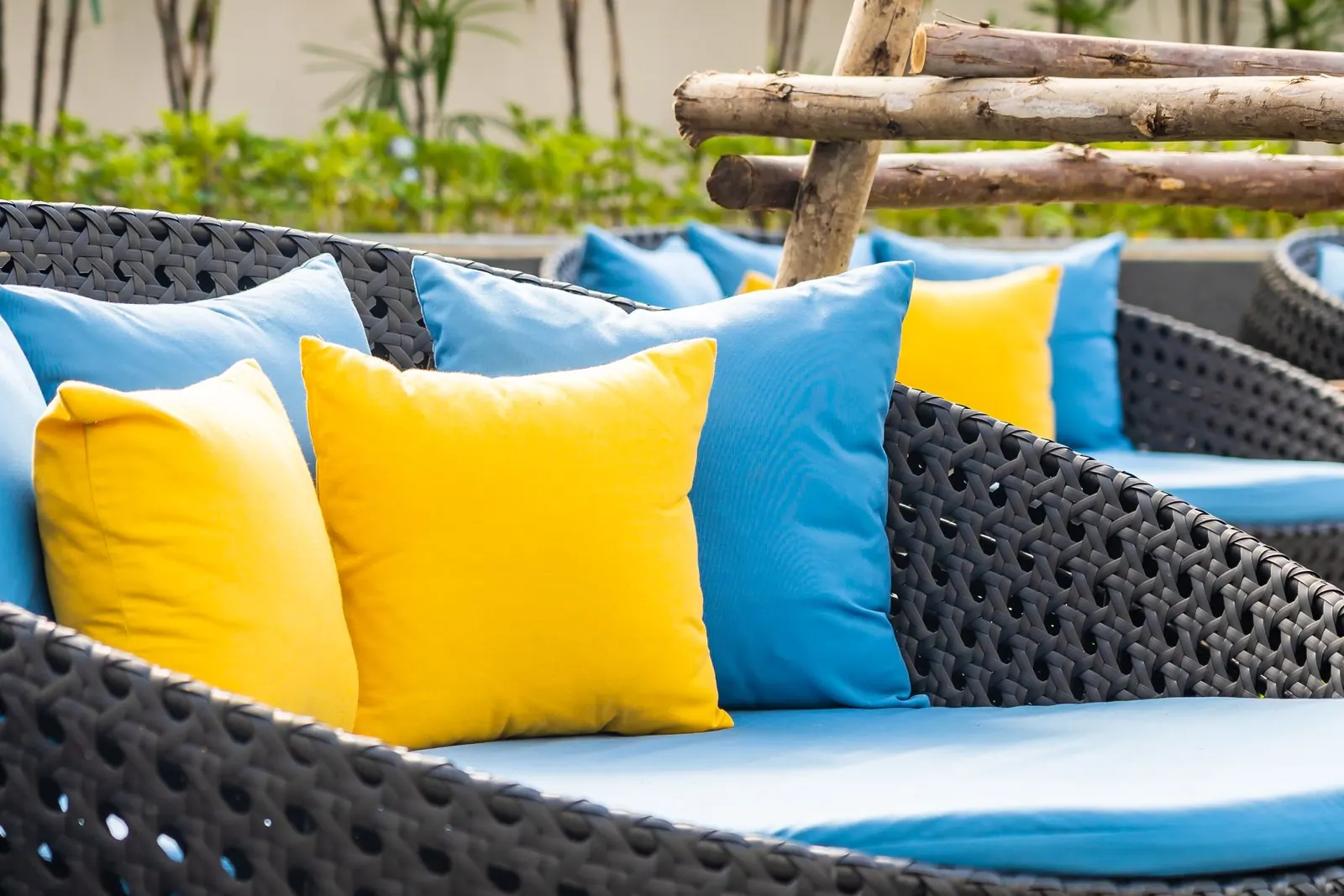 Outdoor patio sofa with yellow and blue pillows