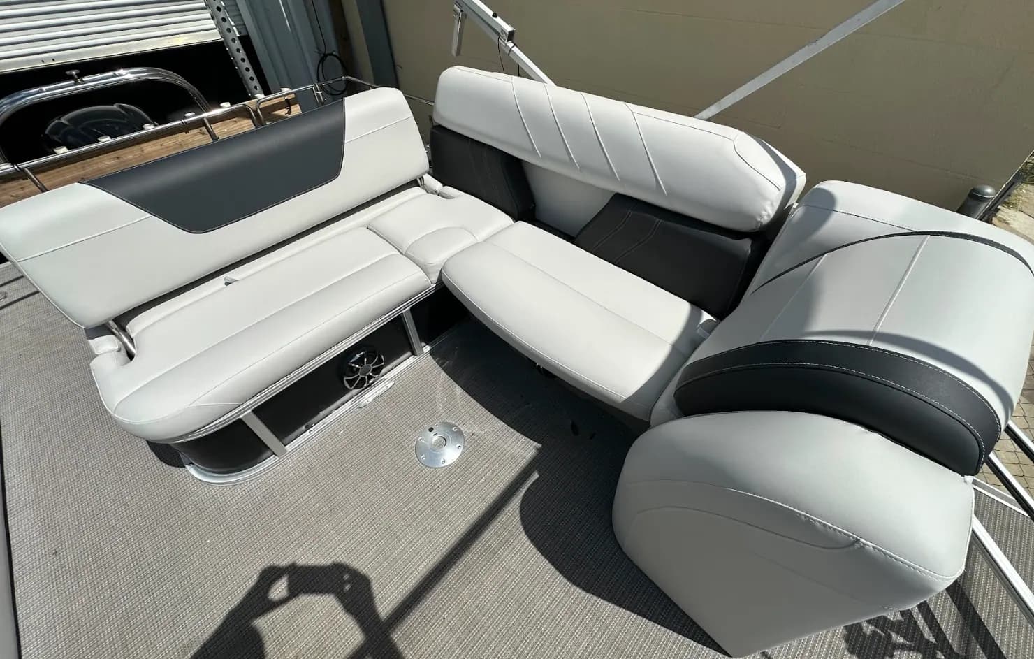 Pontoon boat seating reupholstered in two-tone grey marine vinyl