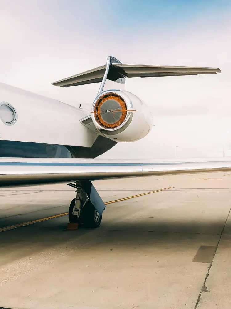 Small private jet parked on the tarmac