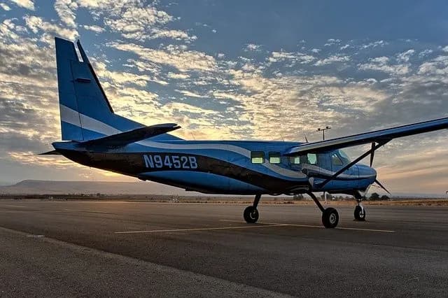 Small single-engine aircraft on the tarmac at sunset