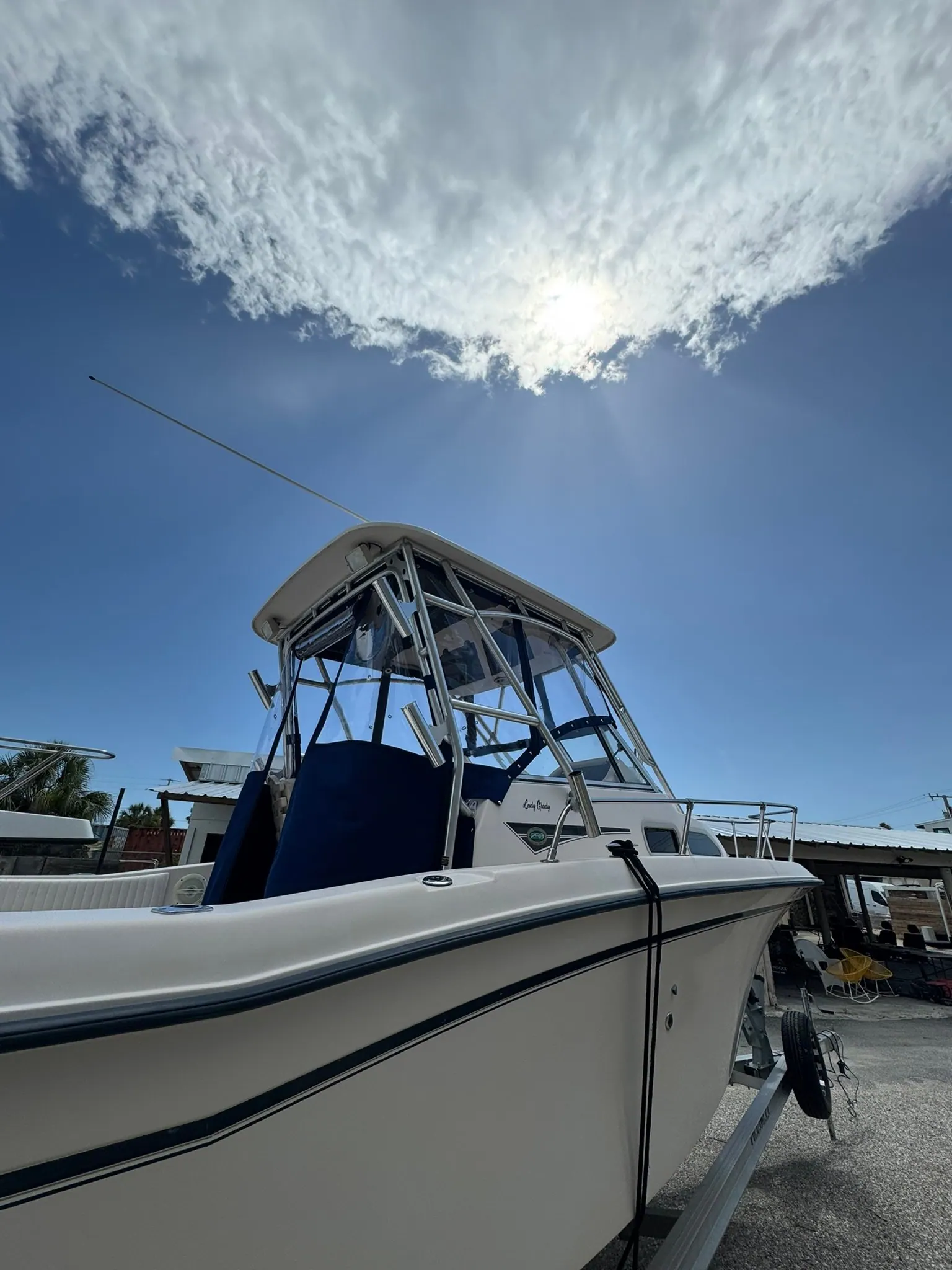 Center console fishing boat with a new custom T-top enclosure in the boat yard in Venice, FL