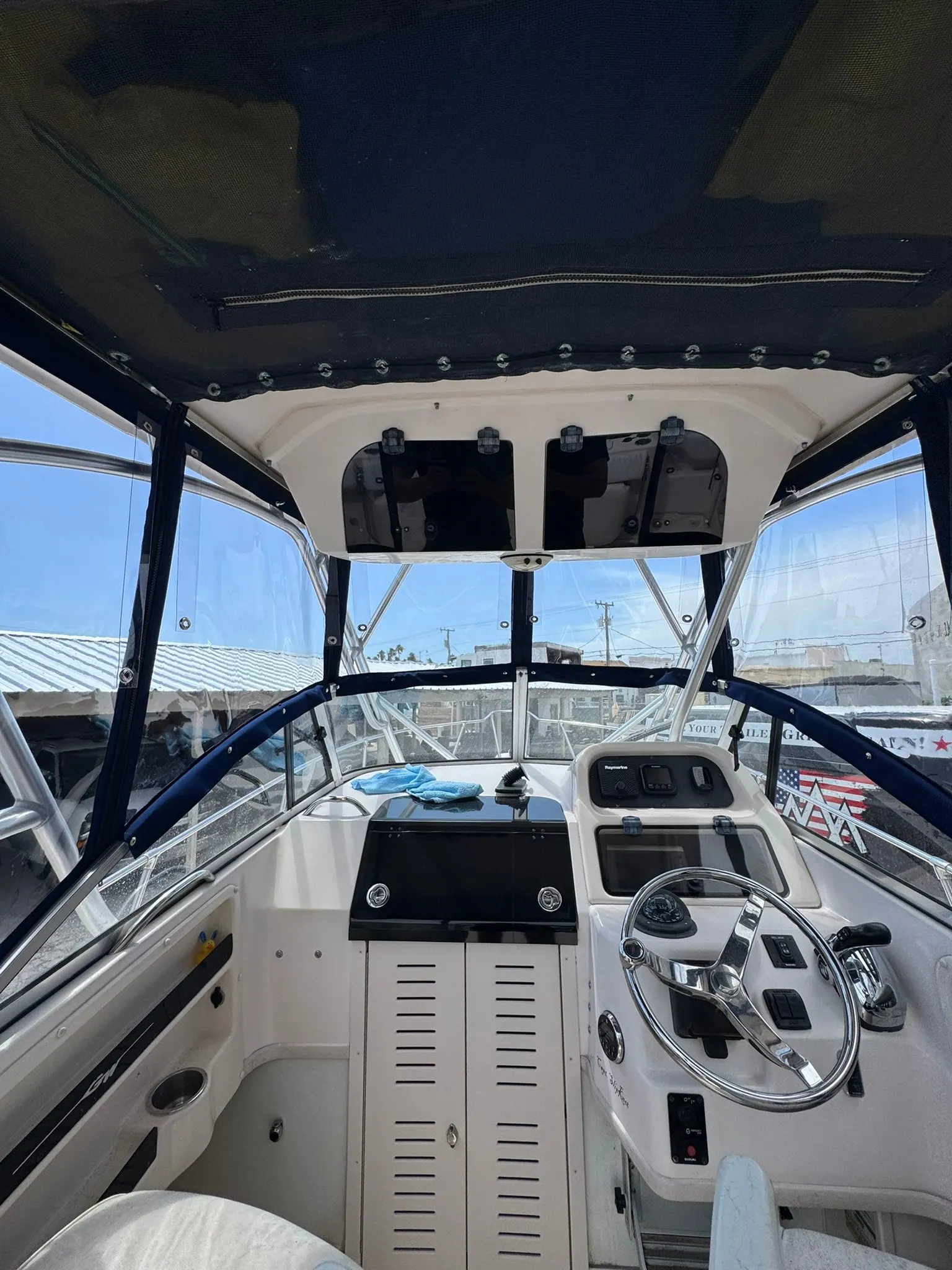 Inside the T-top enclosure showing the clear vinyl windows and zippered panels