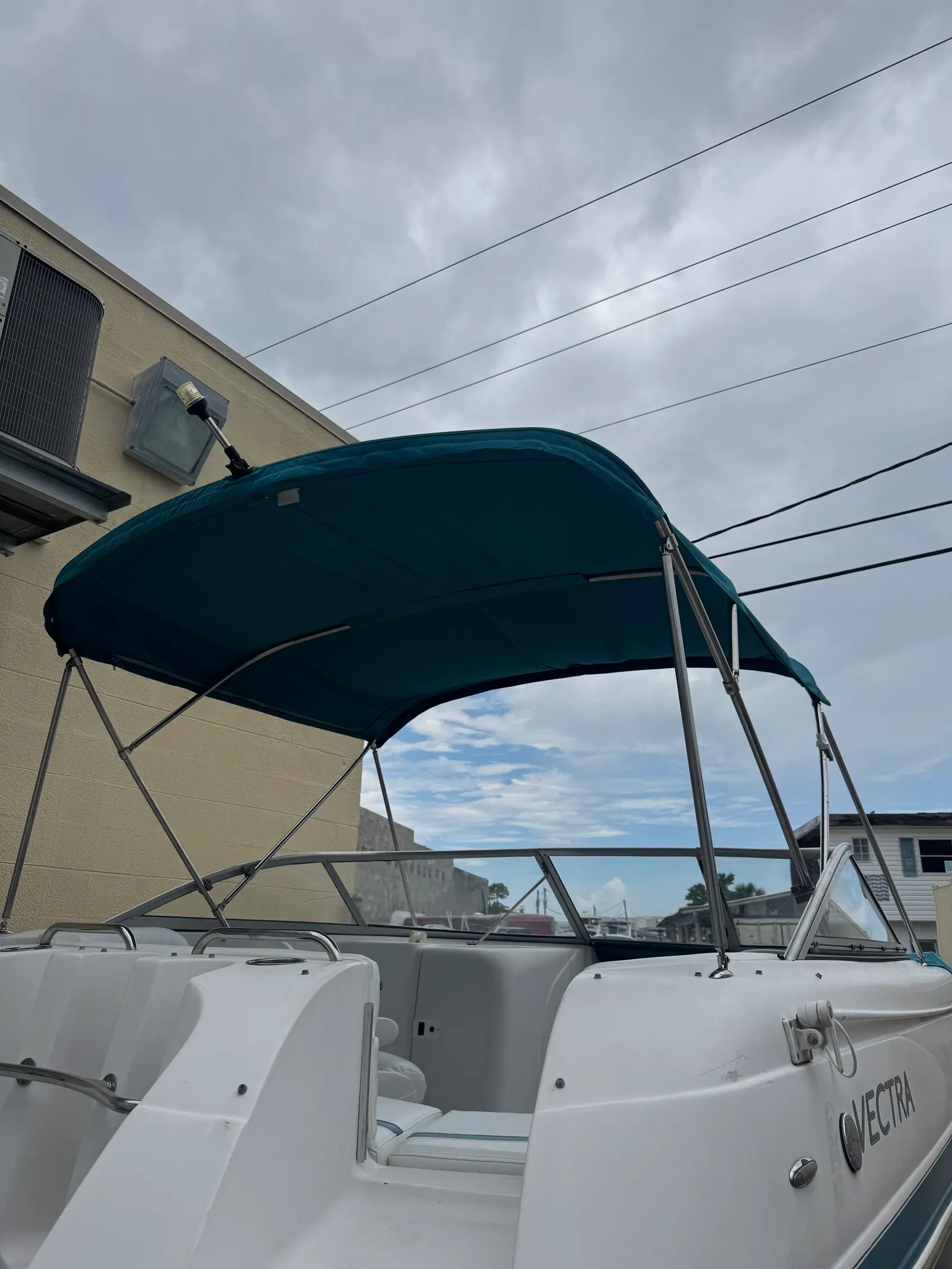 New dark teal bimini top installed on a Vectra deck boat in Venice, FL
