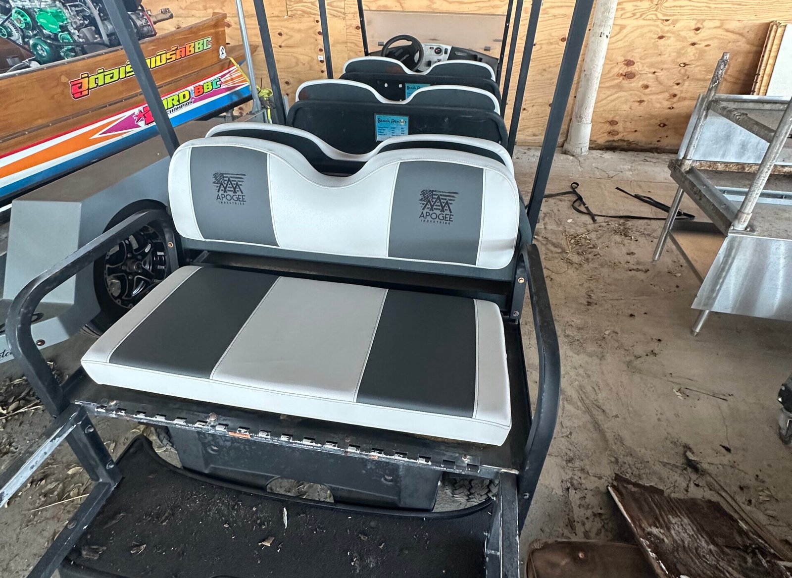 a golf cart with seats in a garage